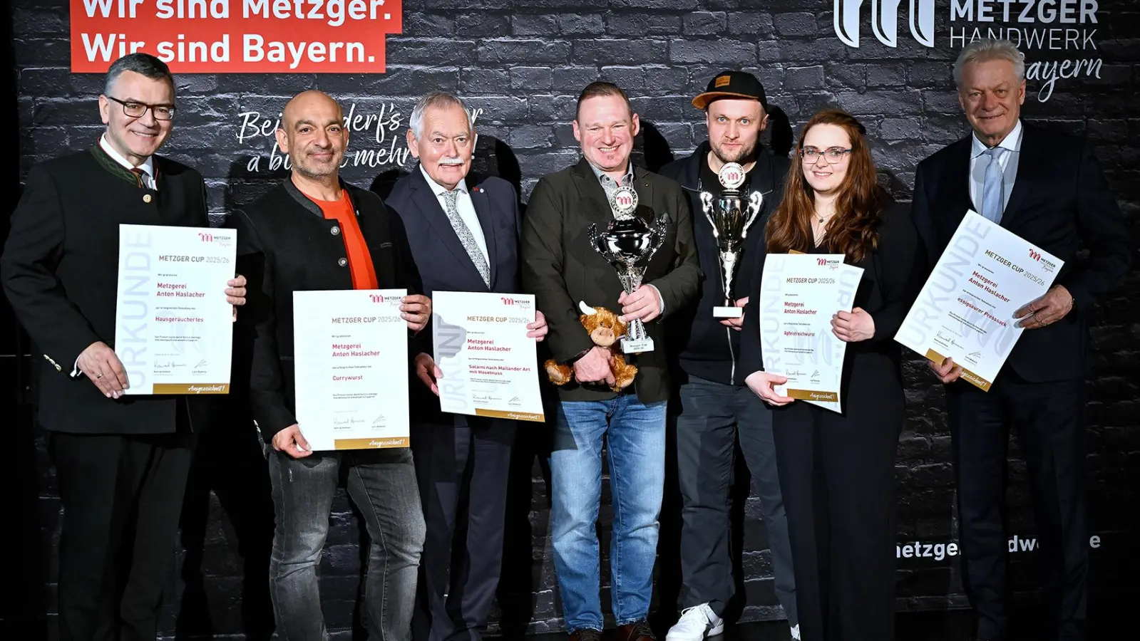 Staatsminister Dr. Florian Herrmann, Comedian Django Asül, Bayerns Landesinnungsmeister, Konrad Ammon, Metzgermeister und Preisträger Anton Haslacher, den stellv. Verkaufsleiter Christian Linke, Anna Haslacher und den Bundeslandwirtschaftsminister Alois Rainer. (v.l.) (Foto: Astrid Schmidhuber)